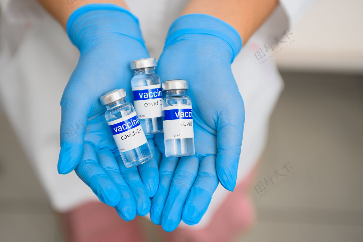 保护一个医生手里拿着装有柯维疫苗的小瓶 快瓶子持有护士
