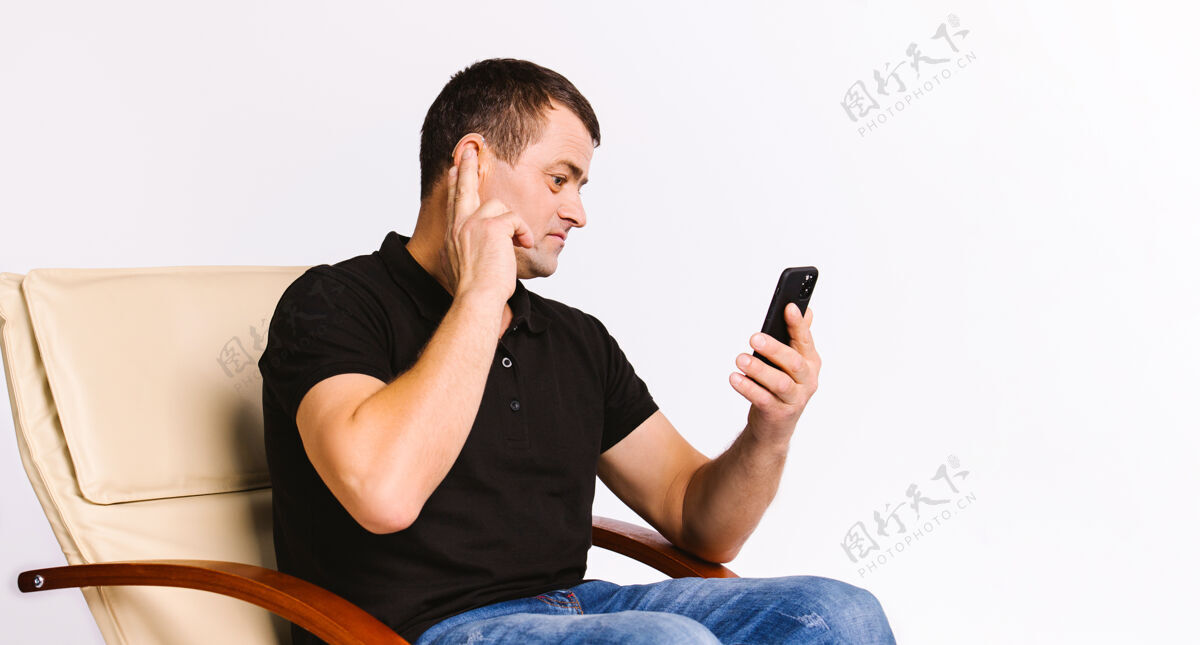 沟通一个白人听力受损男子坐在椅子上 手放在耳朵上的画像手势移动听