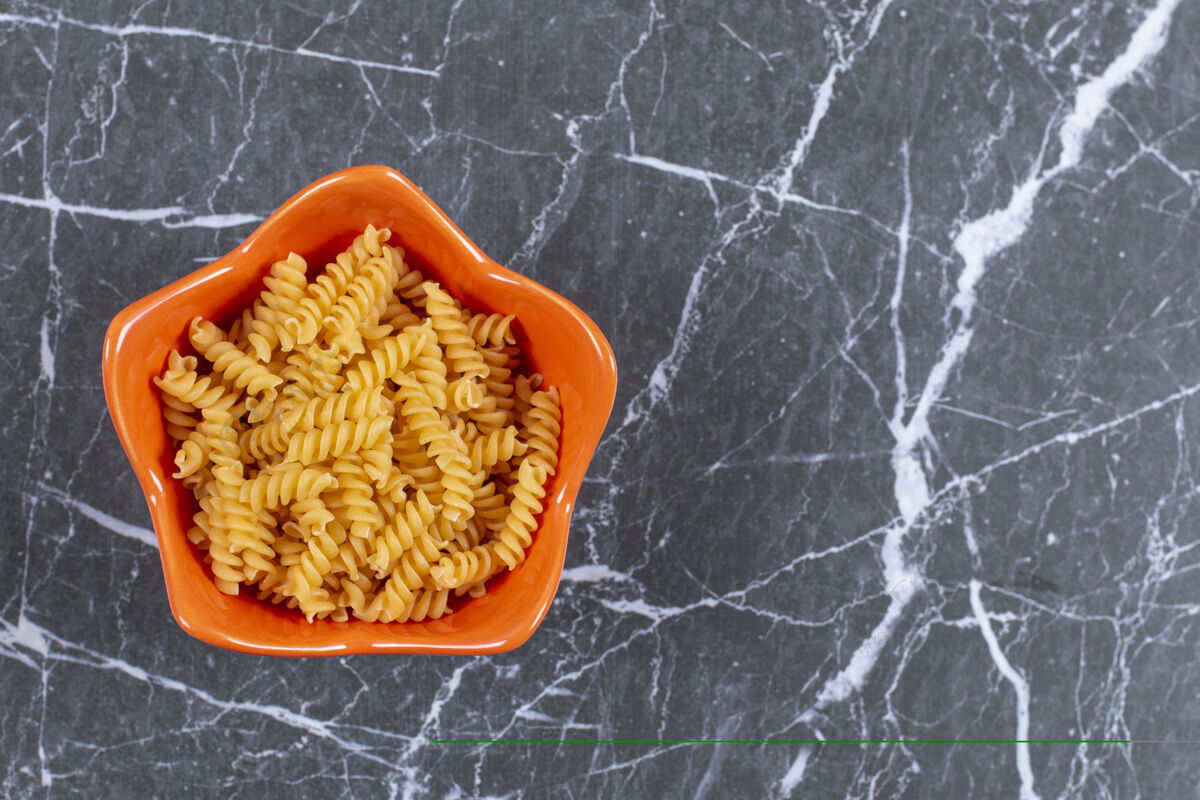 意大利面橙色碗螺旋面食俯视图地中海午餐厨房
