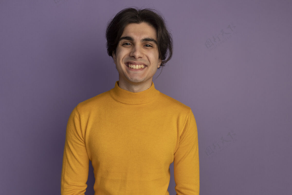 高领毛衣带着微笑的年轻帅哥穿着黄色高领毛衣隔离在紫色的墙上 留着复制空间穿年轻微笑