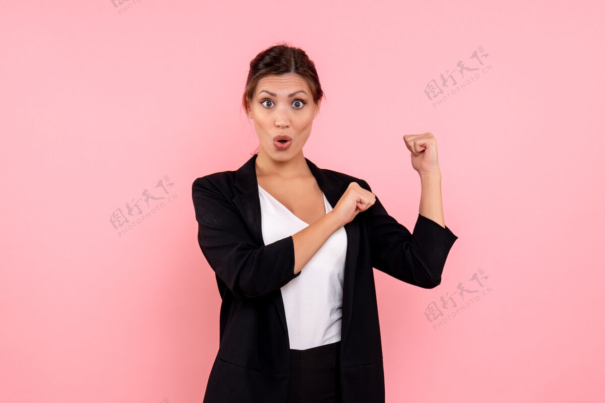 成人正面图：年轻漂亮的女性 穿着粉色背景的深色夹克深色夹克公司