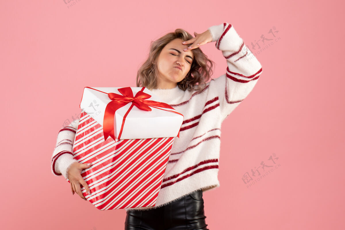 女士前视图年轻女性与圣诞节礼物情感礼物粉色