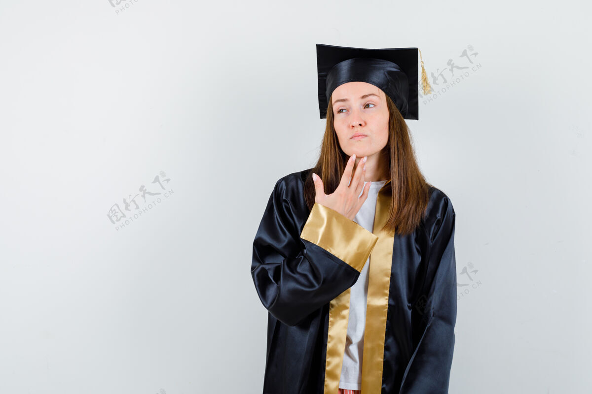 思考年轻的女毕业生穿着学院服站在思考 面带沉思前视女孩女人亚洲人