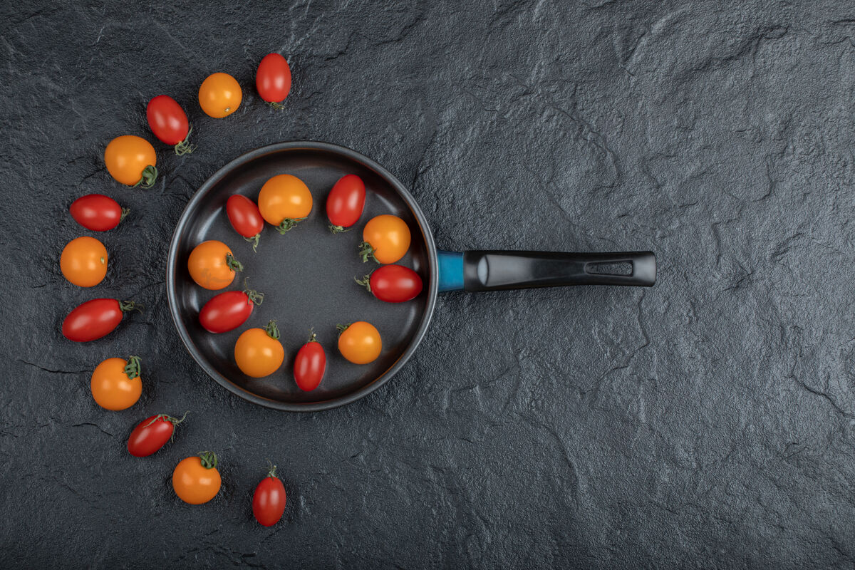 美食果酱色的彩色樱桃番茄在锅上黑色的背景高品质的照片盘子有机饮食
