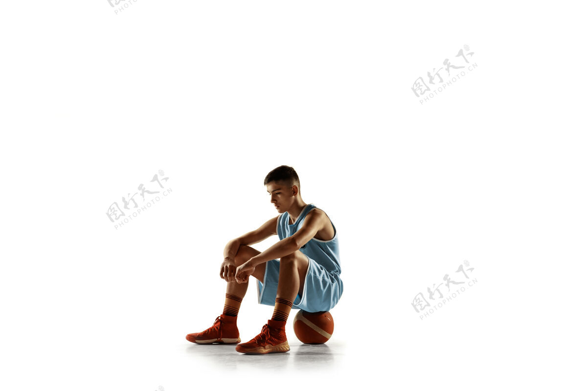 运动在白色工作室背景上 年轻篮球运动员拿着一个球的全长肖像青少年自信地拿着球摆姿势运动的概念 运动 健康的生活方式 广告 动作 动作球肖像活跃