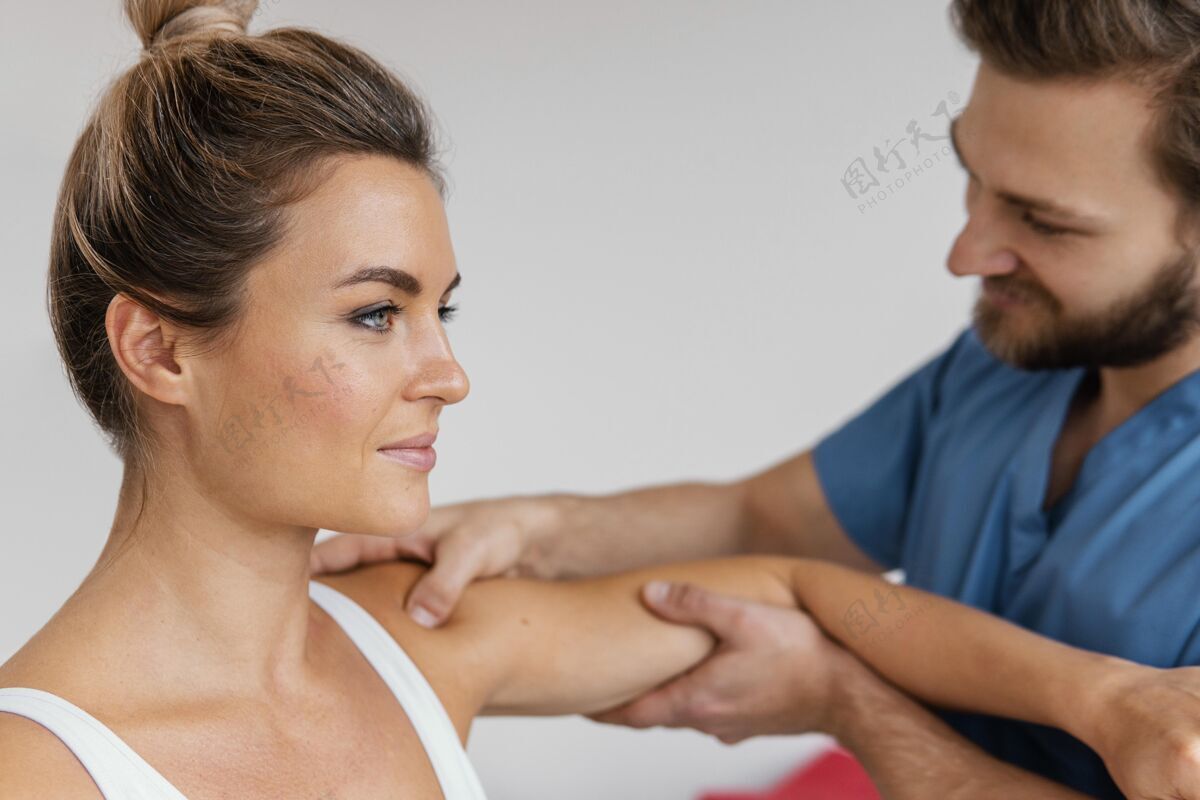 医生骨科治疗师检查女性患者肩部的侧视图女人水平男人