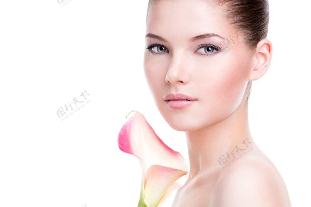 肖像年轻漂亮的女人美丽的脸庞 健康的皮肤 粉色的花朵 白色的隔离人干净性感